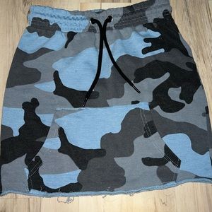 Partially distressed blue cargo cotton skirt with front pocket and pull strings